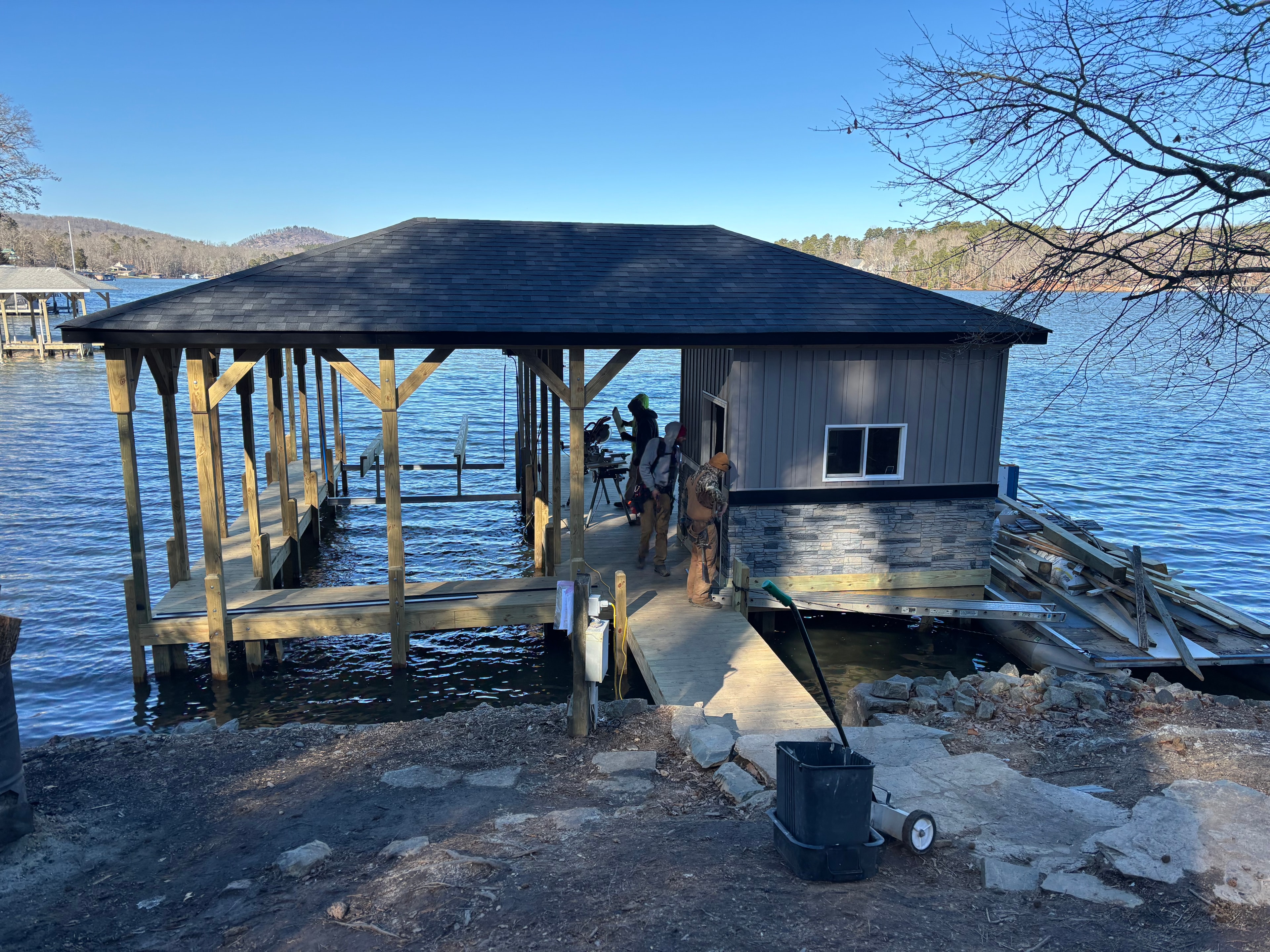 SHT Construction — boathouse under construction with stone veneer base