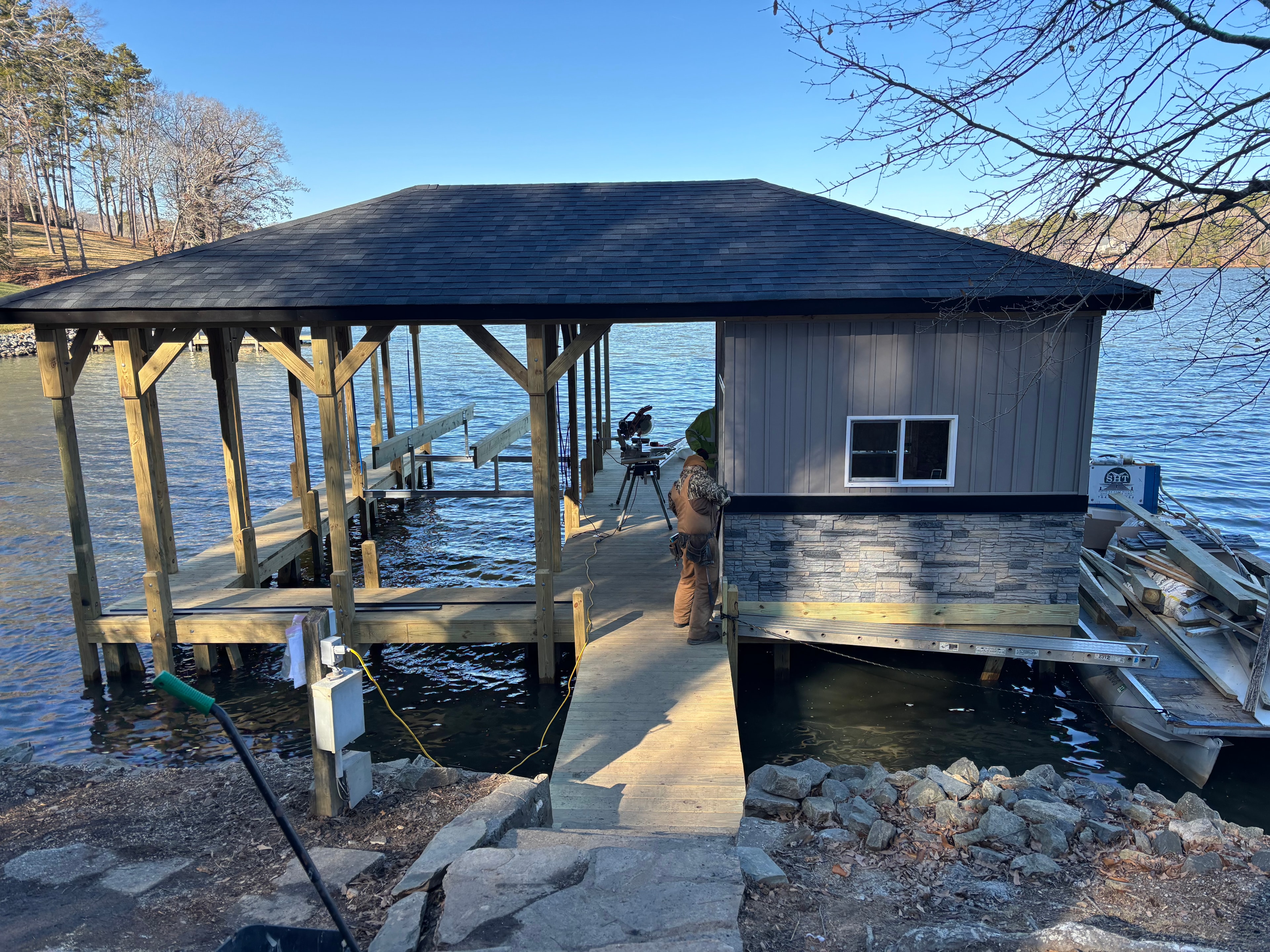 SHT Construction — boathouse framing and dock construction in progress