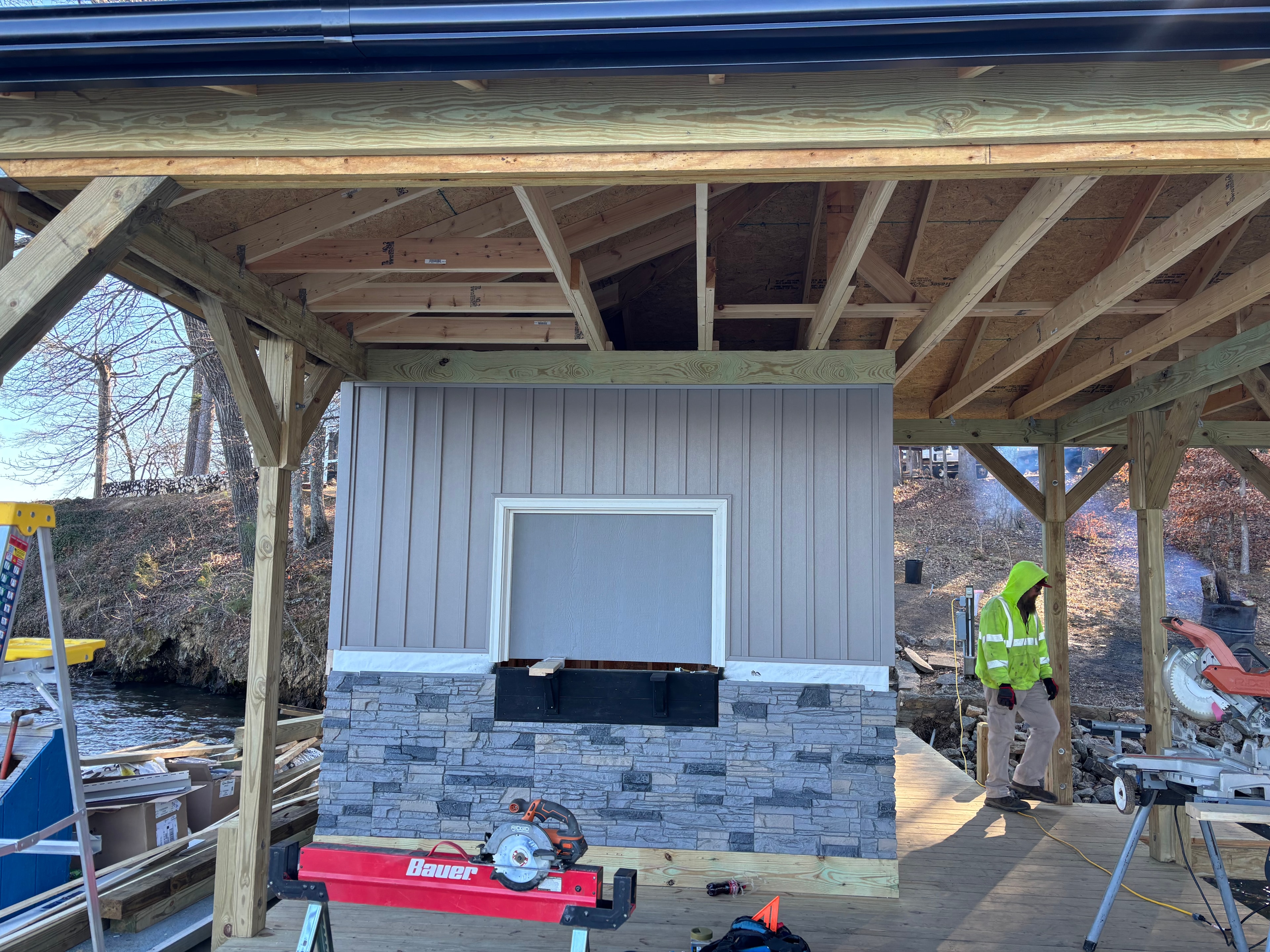 SHT Construction — boathouse interior framing with stone veneer and window installation